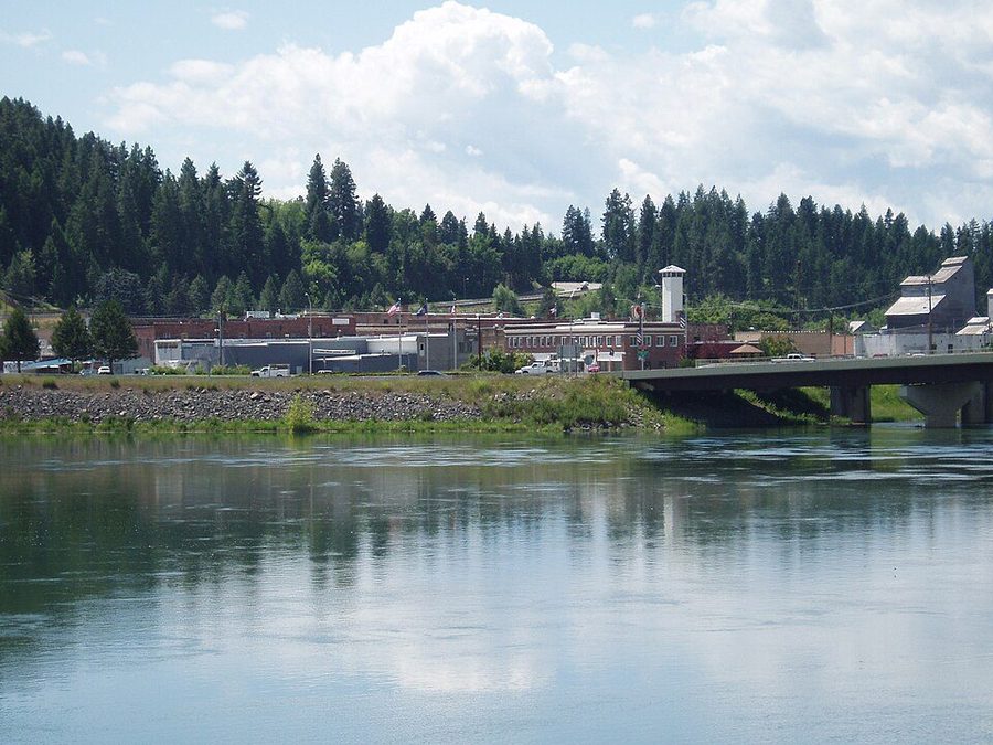 Bonners Ferry, Idaho, seen along the Kootenai River — the town on the bank with the wide river in the foreground.