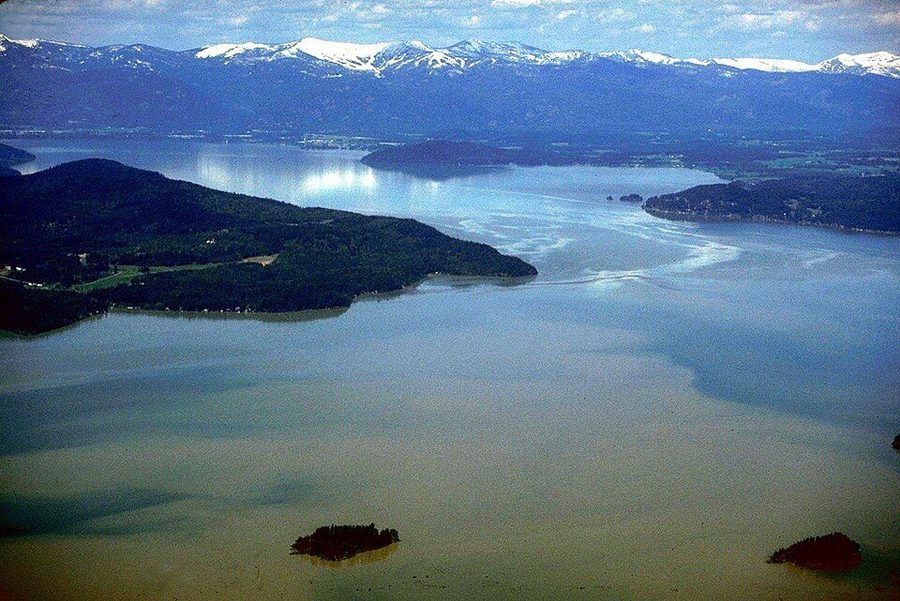 Lake Pend Oreille in northern Idaho — a wide blue lake ringed by forested mountains.
