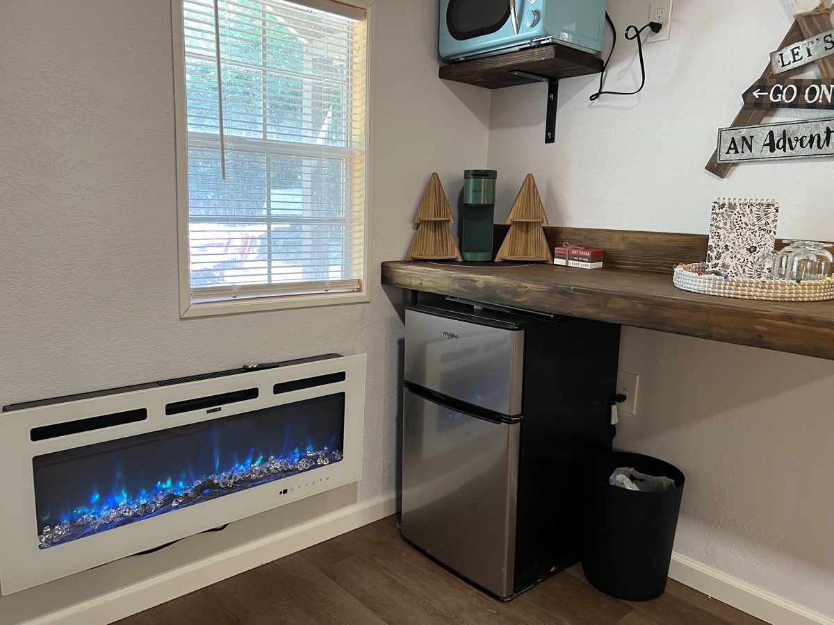 Cabin kitchenette with electric fireplace