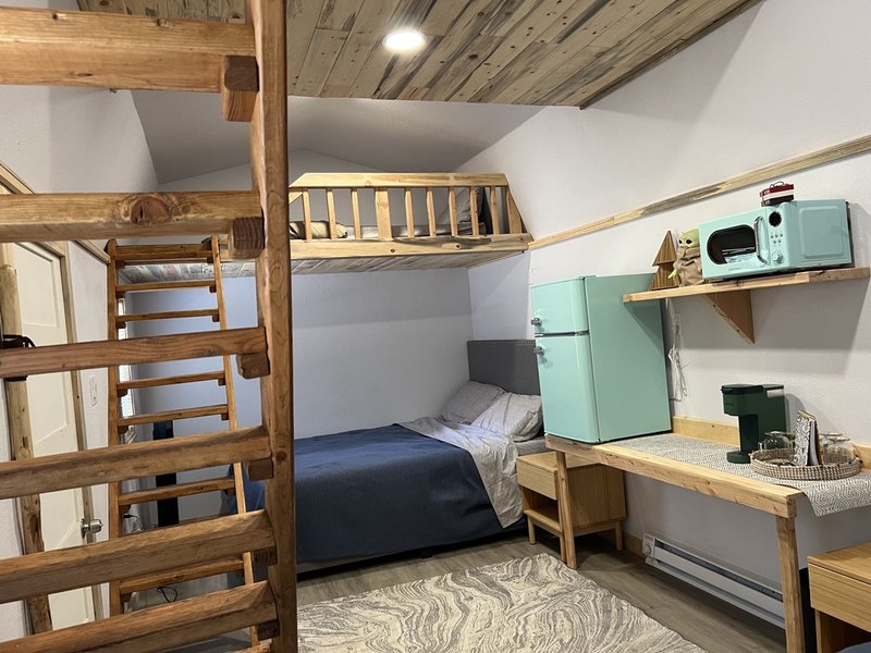Inside The Moose — a bright, brand-new studio cabin at Round Mountain Retreat furnished for six guests.